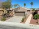 Exterior of desert home with a two-car garage, desert landscaping, and well-manicured front yard at 4124 Gliding Gulls Ave, North Las Vegas, NV 89084