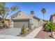 Single story house with mature landscaping including palm trees and desert accents at 4124 Gliding Gulls Ave, North Las Vegas, NV 89084