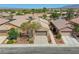 Exterior shot of desert home with two-car garage, xeriscaping, palm trees, and lush desert trees at 4124 Gliding Gulls Ave, North Las Vegas, NV 89084