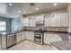 Kitchen showcasing granite countertops, stainless steel appliances, and tile flooring at 4124 Gliding Gulls Ave, North Las Vegas, NV 89084