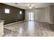 Spacious living room with tile flooring, fan, and access to back patio at 4124 Gliding Gulls Ave, North Las Vegas, NV 89084