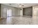 Living room featuring tile floors, fan, with access to patio and other rooms at 4124 Gliding Gulls Ave, North Las Vegas, NV 89084