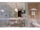 Bathroom featuring a glass-enclosed shower, marble countertops, modern fixtures, and ample lighting at 4381 W Flamingo Rd # 3818, Las Vegas, NV 89103