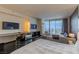 Bright bedroom offers city views, dark wood floors, and a modern desk and television setup at 4381 W Flamingo Rd # 3818, Las Vegas, NV 89103