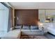 Inviting living room, wood accent wall, with balcony and a mirrored wall behind the bed at 4381 W Flamingo Rd # 3818, Las Vegas, NV 89103