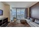 Cozy living room with plush seating and city views from a large balcony window at 4381 W Flamingo Rd # 3818, Las Vegas, NV 89103