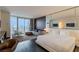 Modern living room features a comfortable sofa and expansive city views from a large window at 4381 W Flamingo Rd # 3818, Las Vegas, NV 89103
