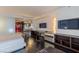 Bright living room featuring dark wood floors, sleek furniture, and a partial kitchen view at 4381 W Flamingo Rd # 3818, Las Vegas, NV 89103