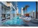 Stunning pool area with modern lounge chairs and surrounding buildings, perfect for relaxation and leisure at 4381 W Flamingo Rd # 3818, Las Vegas, NV 89103