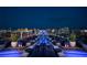 Expansive rooftop lounge area with plush seating and panoramic city views at night at 4381 W Flamingo Rd # 3818, Las Vegas, NV 89103