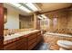 Neutral-toned bathroom with double sinks and shower-over-tub combination at 5242 Dickens Dr, Las Vegas, NV 89119
