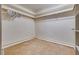 Walk in closet featuring carpet flooring, base molding and wooden closet rods at 5242 Dickens Dr, Las Vegas, NV 89119