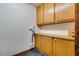 Laundry room featuring built in storage cabinets and laminate flooring at 5242 Dickens Dr, Las Vegas, NV 89119