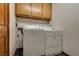 Laundry room featuring a washer, dryer and built in storage cabinets at 5242 Dickens Dr, Las Vegas, NV 89119