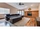 Comfortable living room with brick fireplace and a large sectional, perfect for relaxing and entertaining at 5242 Dickens Dr, Las Vegas, NV 89119