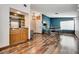 Open-concept living room with wood floors, a bar area, and a workspace creating an inviting space at 5242 Dickens Dr, Las Vegas, NV 89119