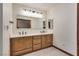 Bright bathroom featuring double sinks, tile flooring and modern lighting fixtures at 5242 Dickens Dr, Las Vegas, NV 89119