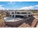 Aerial view of a modern home with a swimming pool, lounge area, and lush landscaping with mountain views at 53 Falling Ridge Ln, Henderson, NV 89011