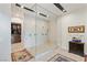 Elegant bathroom featuring a large walk-in shower, seating, and access to a walk-in closet at 53 Falling Ridge Ln, Henderson, NV 89011
