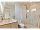 Modern bathroom featuring a glass-enclosed shower, tiled walls, and a contemporary vanity with a large mirror at 53 Falling Ridge Ln, Henderson, NV 89011