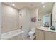 Bright bathroom featuring a soaking tub, a modern toilet, a rain shower, and a sleek vanity with a large mirror at 53 Falling Ridge Ln, Henderson, NV 89011