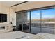 Bedroom featuring large sliding glass doors, outside views, and minimalist decor with a fireplace at 53 Falling Ridge Ln, Henderson, NV 89011
