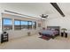 Bedroom with furniture, ceiling fan and a view of the mountains and lake in the distance at 53 Falling Ridge Ln, Henderson, NV 89011