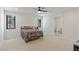 Bright bedroom with carpet floors, two windows, ceiling fan, and an ensuite bathroom with a toilet visible at 53 Falling Ridge Ln, Henderson, NV 89011