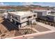 Stunning multi-level home featuring modern design, desert landscaping, and views of the surrounding mountains and lake at 53 Falling Ridge Ln, Henderson, NV 89011