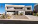 Contemporary home boasts clean lines, stone accents, desert landscaping, and an inviting entrance at 53 Falling Ridge Ln, Henderson, NV 89011