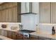 The kitchen boasts a sleek cooktop, stainless steel hood, and backsplash for a modern touch at 53 Falling Ridge Ln, Henderson, NV 89011