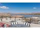 Stunning lake view from the patio with outdoor furniture and mountain backdrop on a sunny day at 53 Falling Ridge Ln, Henderson, NV 89011