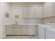 Functional laundry room with ample cabinet space and modern appliances at 53 Falling Ridge Ln, Henderson, NV 89011