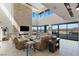 This impressive living room has high ceilings, multiple seating areas and beautiful views through the floor to ceiling glass at 53 Falling Ridge Ln, Henderson, NV 89011