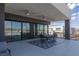 Luxury patio area with seating, outdoor dining area, and expansive sliding glass doors to the indoors at 53 Falling Ridge Ln, Henderson, NV 89011