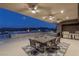 Covered patio with outdoor dining area, BBQ grill, and a luxurious pool with fire features and stunning mountain views at 53 Falling Ridge Ln, Henderson, NV 89011