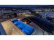 Aerial view of a luxurious pool with fire features and lounge chairs, nestled within a modern residential neighborhood at 53 Falling Ridge Ln, Henderson, NV 89011