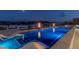 Modern pool with integrated lighting and lounge seating, perfect for evening relaxation with panoramic views of the city at 53 Falling Ridge Ln, Henderson, NV 89011