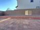 Spacious backyard featuring pavers, gravel landscaping, and wall for privacy at 5817 Bonita Rose St, Las Vegas, NV 89113