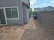 This backyard boasts a stone pathway, rock ground cover, and a sturdy block fence for privacy at 5817 Bonita Rose St, Las Vegas, NV 89113