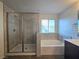 Modern bathroom with walk-in shower and soaking tub at 5817 Bonita Rose St, Las Vegas, NV 89113