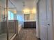 Bathroom featuring a shower, bathtub, double vanity, and modern finishes, offering a serene and stylish space at 5817 Bonita Rose St, Las Vegas, NV 89113
