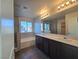 Modern bathroom with dual vanity, a soaking tub, and walk-in shower at 5817 Bonita Rose St, Las Vegas, NV 89113