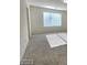 Spacious bedroom with plush carpeting, neutral paint, and a window for natural lighting at 5817 Bonita Rose St, Las Vegas, NV 89113