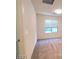 Inviting bedroom with neutral paint, plush carpet, and large window providing ample natural light at 5817 Bonita Rose St, Las Vegas, NV 89113