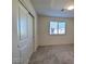Neutral bedroom with carpet, bright window, and large closet with sliding doors at 5817 Bonita Rose St, Las Vegas, NV 89113