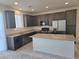 Modern kitchen with granite countertops, stainless steel appliances, and a central island at 5817 Bonita Rose St, Las Vegas, NV 89113