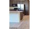 Bright and modern kitchen island with stainless steel appliances and dark wood cabinetry at 5817 Bonita Rose St, Las Vegas, NV 89113
