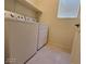Functional laundry room equipped with a washer, dryer, and built-in storage for convenience at 5817 Bonita Rose St, Las Vegas, NV 89113