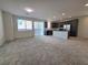 Spacious living room and modern kitchen with stainless steel appliances and island at 5817 Bonita Rose St, Las Vegas, NV 89113